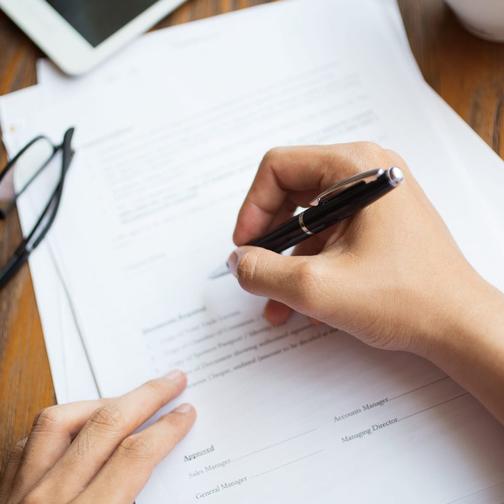 Unrecognizable man filling application form. Businessman checking papers. He signing document. Manager working with report. Financial report concept